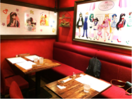 The café interiors with Sailor Moon art on the walls.